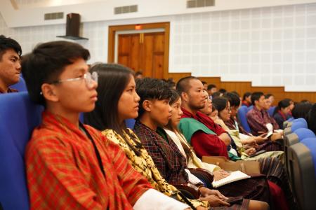 Participants attending the Bhutan International Youth Day 2025 celebration under the global theme “Local Youth Actions for the SDGs and Beyond". They are seated and looking towards the stage at the venue auditorium.  